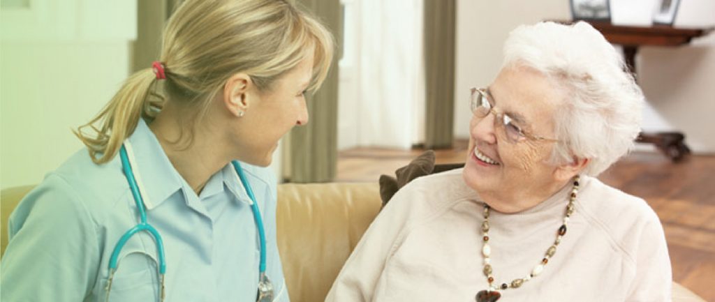 Elderly lady in aged care facility with nurse