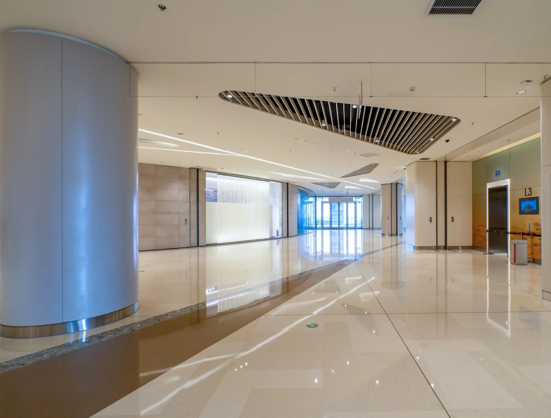Building Interior with divider on right side and a long walking hall